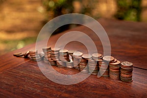 Thai bath coin 25 satang lots on wooden table with blurred background, Money of Thailand, Investment and saving concept, Money