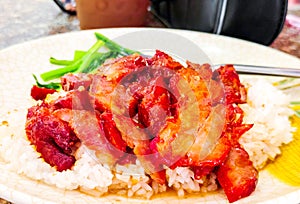 Thai BBQ red pork with rice on white dish. Thailand street food