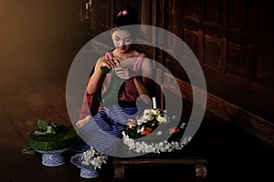 Thai beautiful women wearing traditional dresses make Krathong f