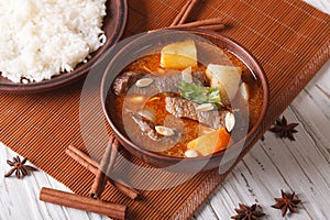 Thai beef massaman curry with peanuts and rice side dish