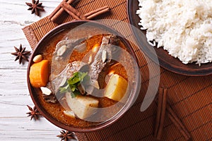 Thai beef massaman curry and rice side dish closeup. horizontal