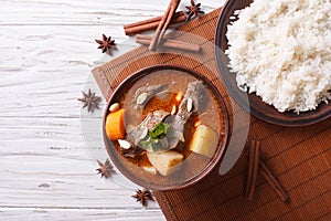 Thai beef massaman curry and rice side dish. horizontal top view photo