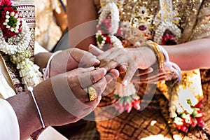 Thai bride and groom in Ceremony wearing a wedding ring of marriage celebration thai style at retro home in countryside of