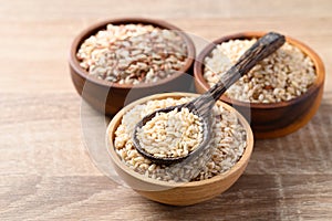 Thai brown rice seed in wooden bowl with spoon, Organic rice