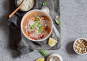 Thai carrot sweet potato soup with rice on the dark table, top view.