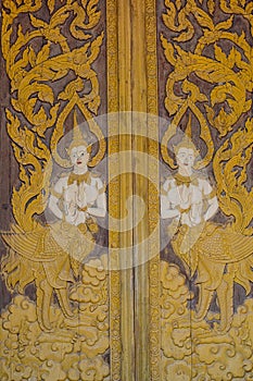 Thai carve on wooden board door style , in the temple at Norther