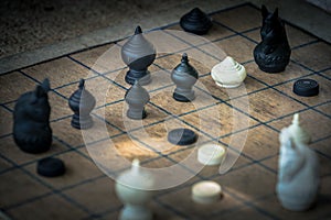 Thai Chess Figure on Wood Checkerboard, Tactics and Strategy Concept photo