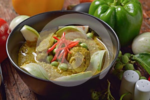 Thai chicken green curry with wooden background