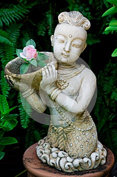Thai child statue in a garden
