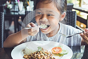 Thai children eating in restaurant