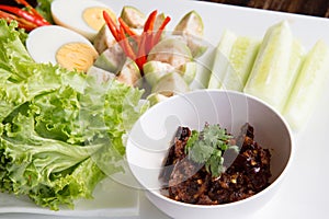 Thai chili paste Nam Prik dip served with long bean, cucumber, white turmeric, boiled egg, eggplant and carrot, Thai traditional