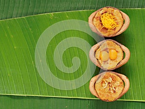 Thai coconut custard pudding dessert, Maw Gaeng, in clay pot on banana leaf background