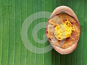 Thai coconut custard pudding dessert, Maw Gaeng, in clay pot on banana leaf background