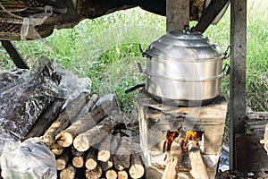 Thai cooking style, steam pot on vintage local fire-stove in kitchen of old wooden house