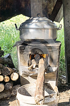 Thai cooking style, steam pot on vintage local fire-stove in kitchen of old wooden house