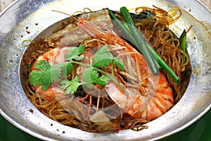 Thai cuisine, steamed prawns with vermicelli in metal casserole pot