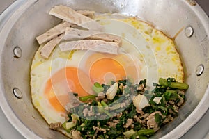 Thai delicious panned eggs on small aluminum pan.