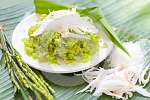 Thai dessert - pounded unripe rice food rice flakes cereal with coconut and sugar, Green rice sweet with ears of rice pandan leaf