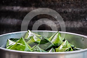 Thai Dessert in Steaming container - Stuffed Dough Pyramid, Thai desserts wrapped in banana