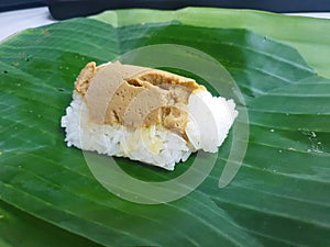 Thai dessert style, Selective focus of sweet sticky rice with Thai custard or Khao Neow Sang Kaya on banana leaf as a  background photo