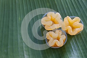 Thai dessert Thong Yip in plastic cup on banana leaf. photo