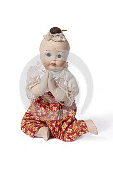 Thai doll, Kuman Thong, sitting and raise her hands to pay respects