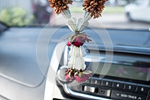 A Thai dried garland, a dried rose leaving in the car. Beliefs of Thailand