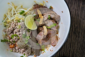 Thai dry noodle with minced pork, entrails in white bowl ceramic