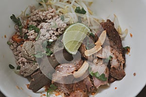 Thai dry noodle with minced pork, entrails in white bowl ceramic