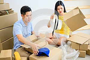 Thai entrepreneur couple are packing. Oline shopping and home delivery. Lock down and Self-quarantine for SME business photo