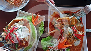 Thai famous food seafood steamed curry and fish in red curry eating full table in Thailand