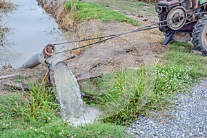 Thai farming methods - Pumping water from the canal to rice fields, Engine, baler from the canal into rice field, The water is