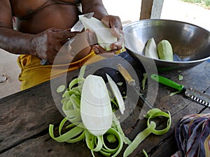 Thai fat old man peeling winter melon for cooking