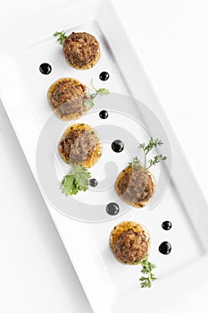 thai fish cake balls in gourmet contemporary restaurant on white background