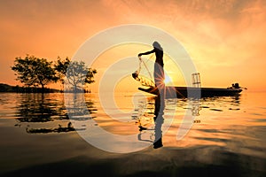 Thai fisherman with net in action
