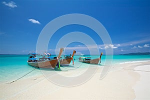 Thai fishing boats on the azure sea on the bounty beach in thailand