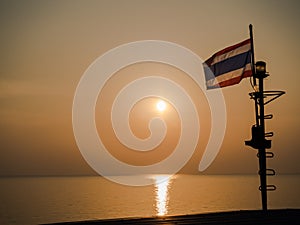 Thai flag on the sea with sunset view