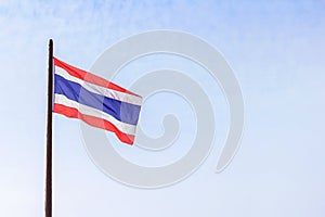 Thai flag waving with light blue sky