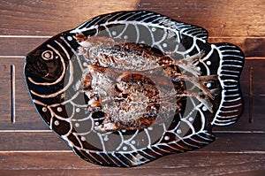Thai food on dinner table, deep fried crispy makerel fish on beautiful plate