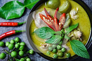 Thai food green curry on soup bowl with ingredient herb vegetable on dark plate background - green curry chicken cuisine asian