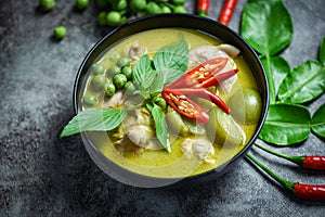 Thai food green curry on soup bowl with ingredient herb vegetable on dark plate background - green curry chicken cuisine asian