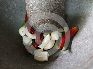 Thai food ingredients, chilli and garlic in a stone mortar