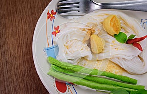 Thai food (kanom jeen) in wood table