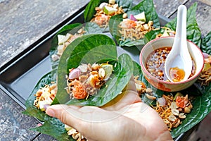 Thai Food Miang Leaf-Wrapped Bite-Size Appetizer photo