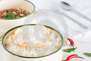 Thai food name Pad Ka Prao, Cooked rice and Fried egg in classic food carrier beside have Stir-fried pork with basil leaves