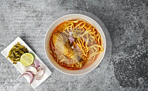 Thai food, Northern Style Curried Noodle Soup with Chicken on gray concrete table