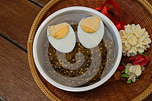 Thai food pound eggplant with boiled egg on wood table