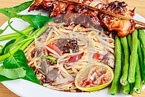 Thai food speak (somtam kaiyang) : Papaya spicy salad with salted crab and Grilled chicken and sticky rice in wicker basket on