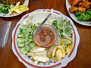 Thai Food Spicy Shrimp Paste Dip name is Nam Prink Kapi with Vegetables Cucumber Sunflower sprout Shoot Taste Salty and Spicy in T