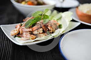 Thai food - spicy Shrimp salad with garlic and basil